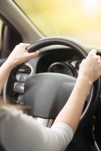 Close-up of female hands hold on the steering wheel — Stock Photo, Image