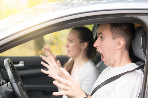 Young scared man driver and a woman passenger — Stock Photo, Image