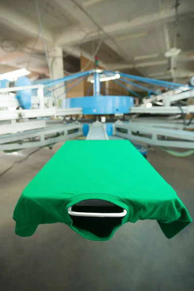 Green clothing on silk screen printing machine — Stock Photo, Image