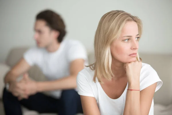 Sad woman thinking over a problem, man sitting aside — Stock Photo, Image