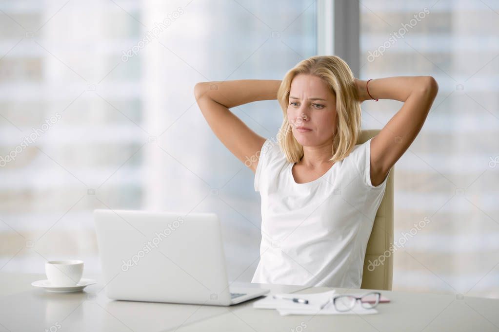 Young depressed woman at laptop