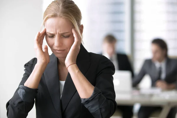 Young businesswoman with headache — Stock Photo, Image