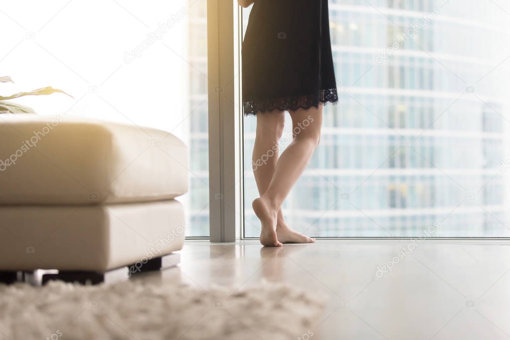 Female legs near the window