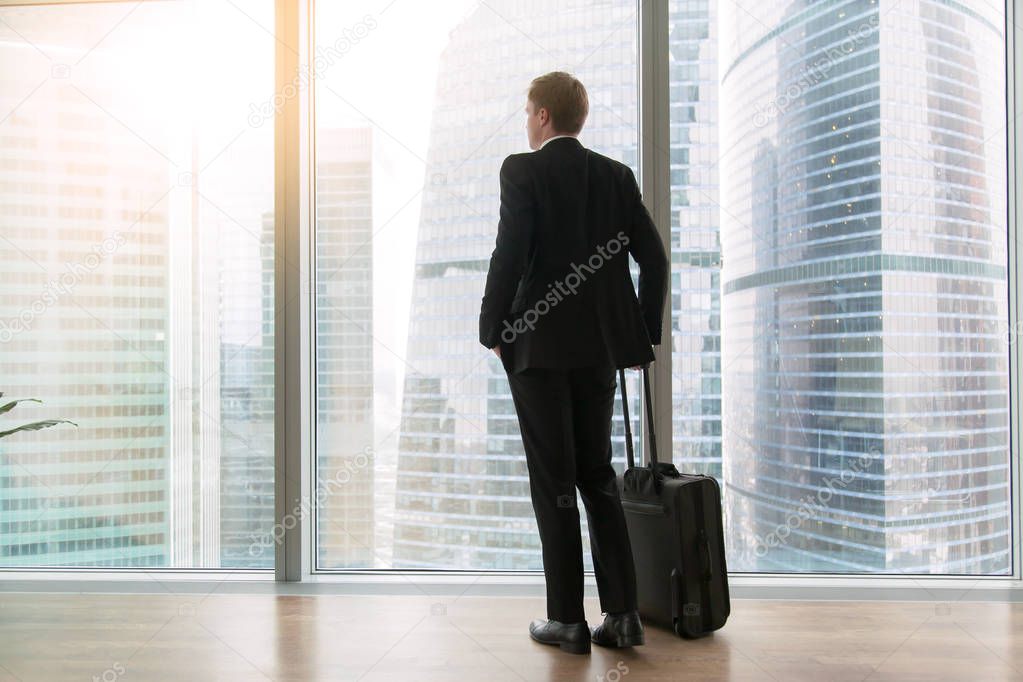 Businessman standing in the empty office