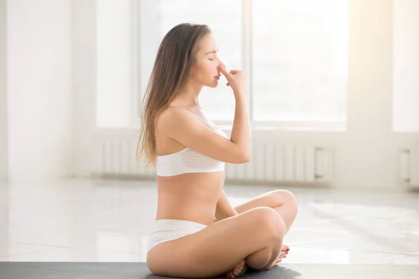 Young attractive woman making Alternate Nostril Breathing, white — Stock Photo, Image