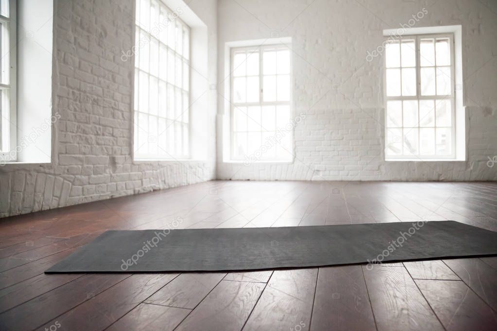 Empty white space, loft studio, yoga mat on the floor