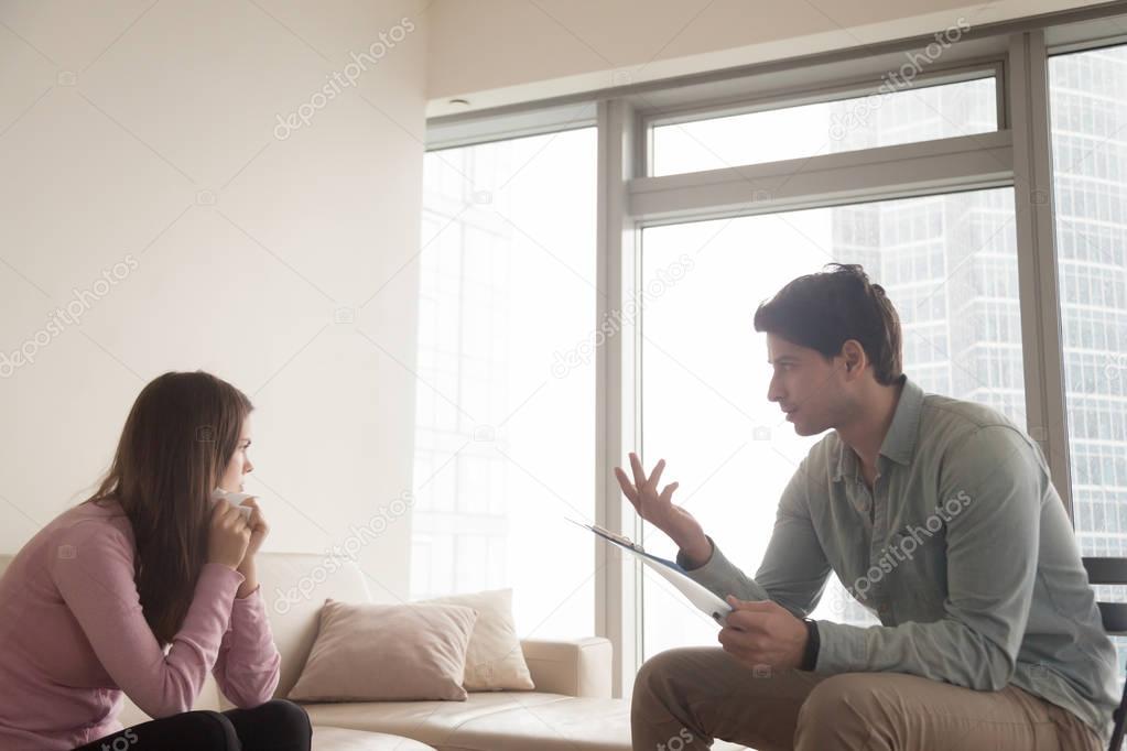 Professional male psychologist talking to upset crying woman, ps