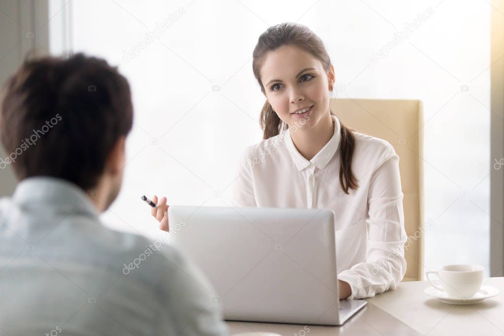 Smiling businesswoman interviewing a job applicant, business mee