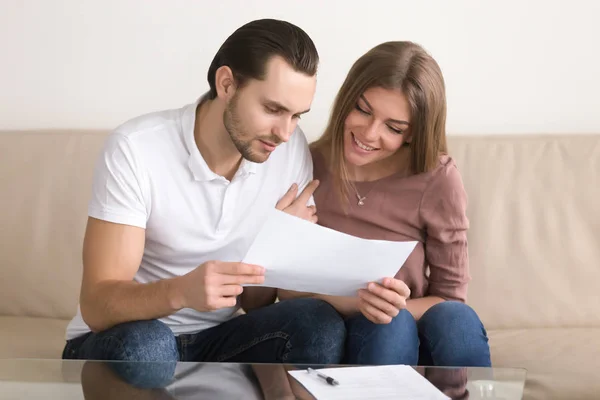 Young couple reading terms and conditions before signing contrac