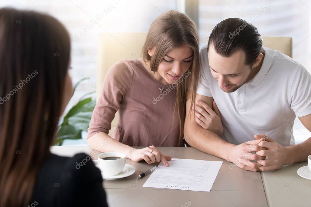 Young family couple taking loan, studying contract agreement bef