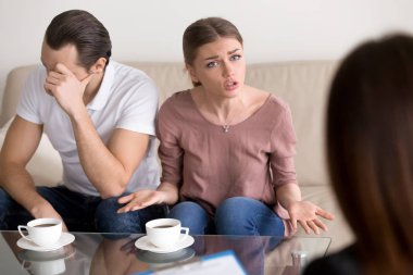 Unhappy emotional wife talking to psychologist about problems in clipart
