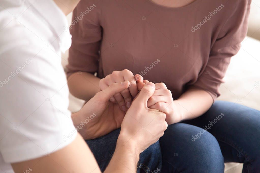 Close up of man holding hands of woman, proposal, apologize