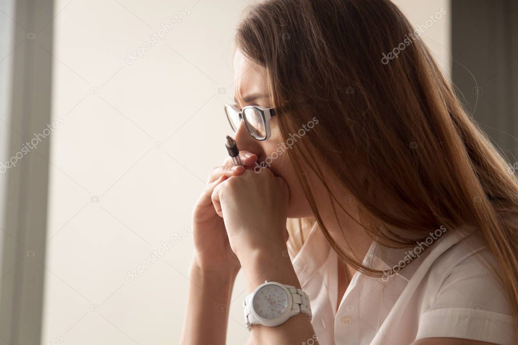 Portrait of worried businesswoman focused on work