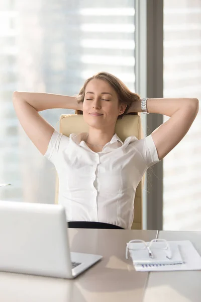 Satisfied businesswoman leaning back in chair — Stock Photo, Image