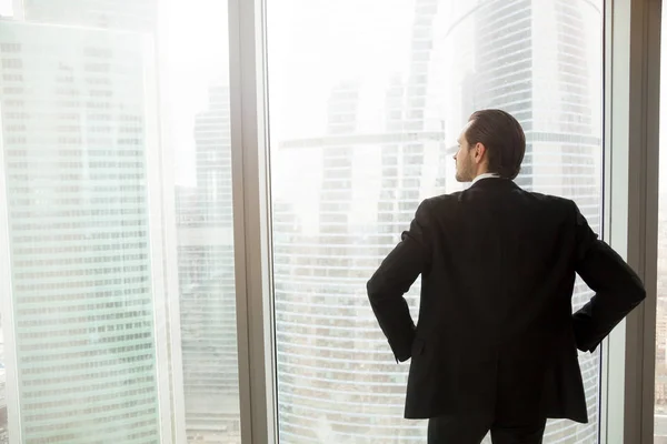 Businessman thinking about future near window — Stock Photo, Image