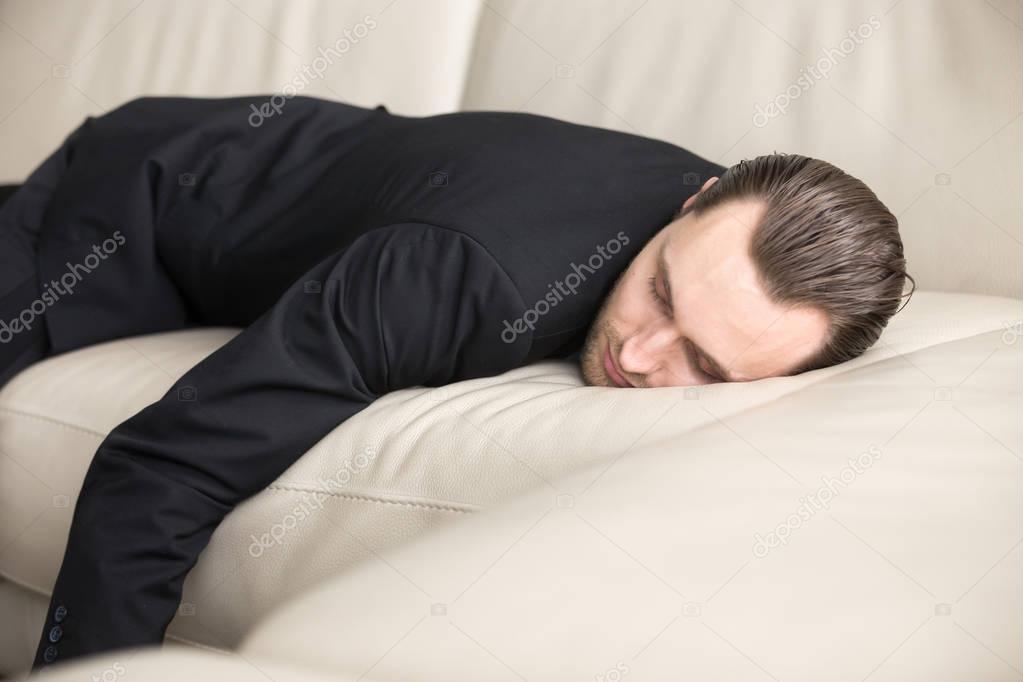 Tired businessman takes break for short sleep