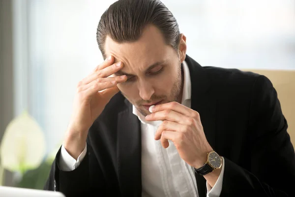 Businessman takes pill from headache in office — Stock Photo, Image