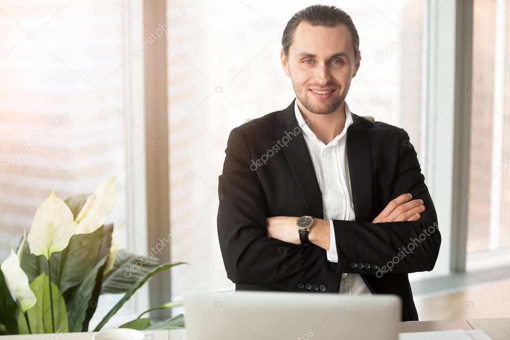 Confident businessman posing at workplace
