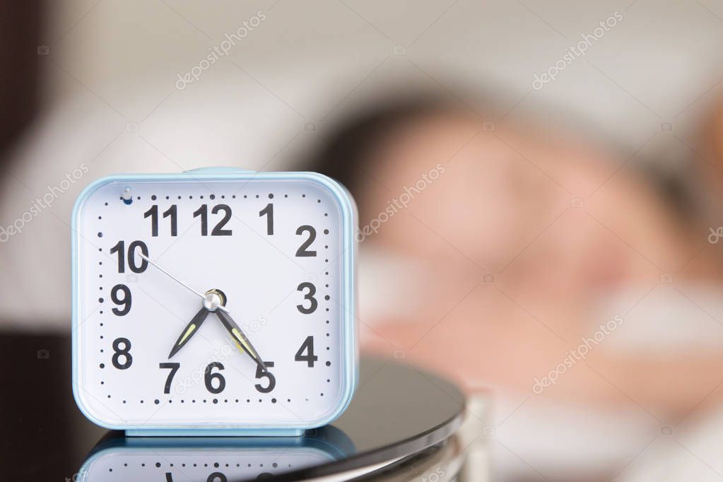 Close up image of alarm clock on bedside table