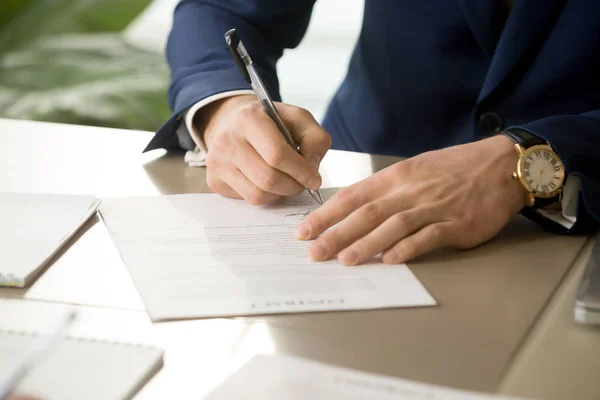 Male hand putting signature on contract, signing document, close — Stock Photo, Image