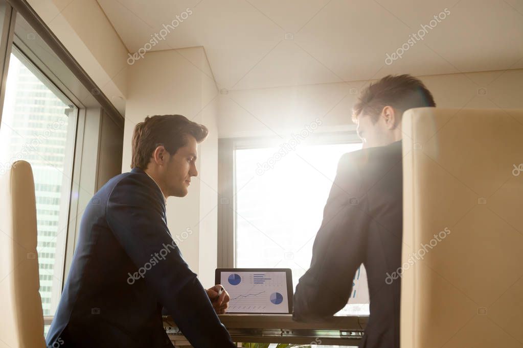 Business audit team working at office desk, analyzing infographi