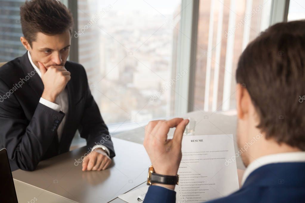 Worried unhired job applicant feeling nervous while employer rev