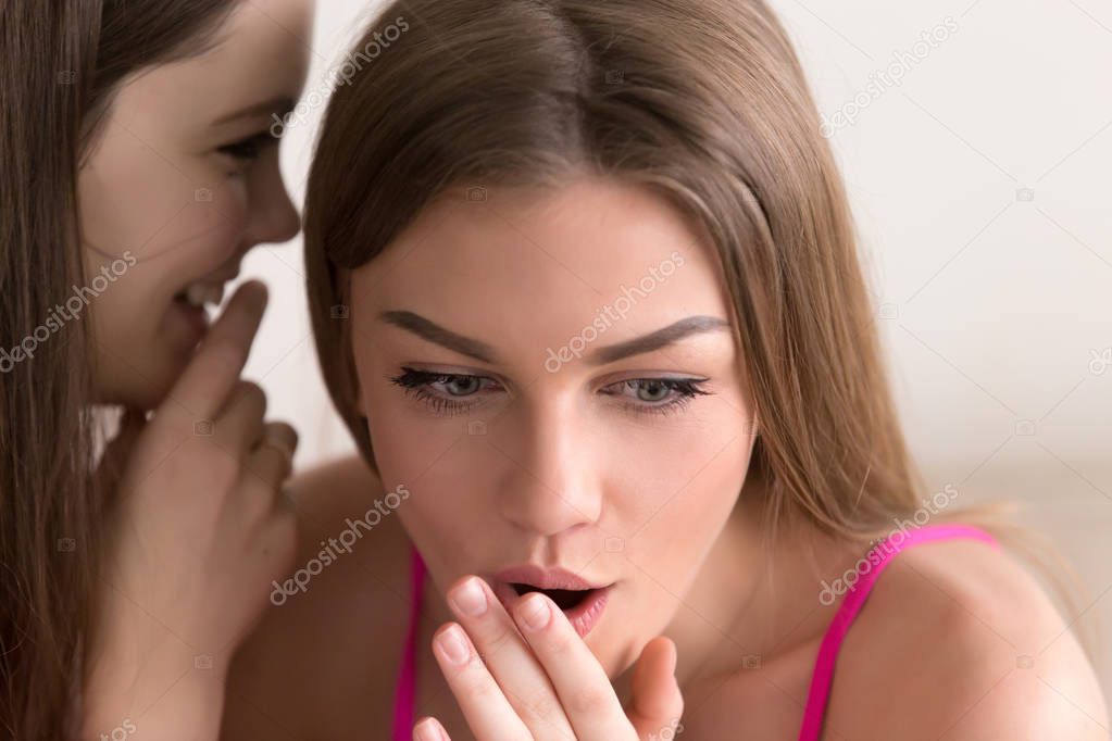 Teen girl sharing with secrets with female friend