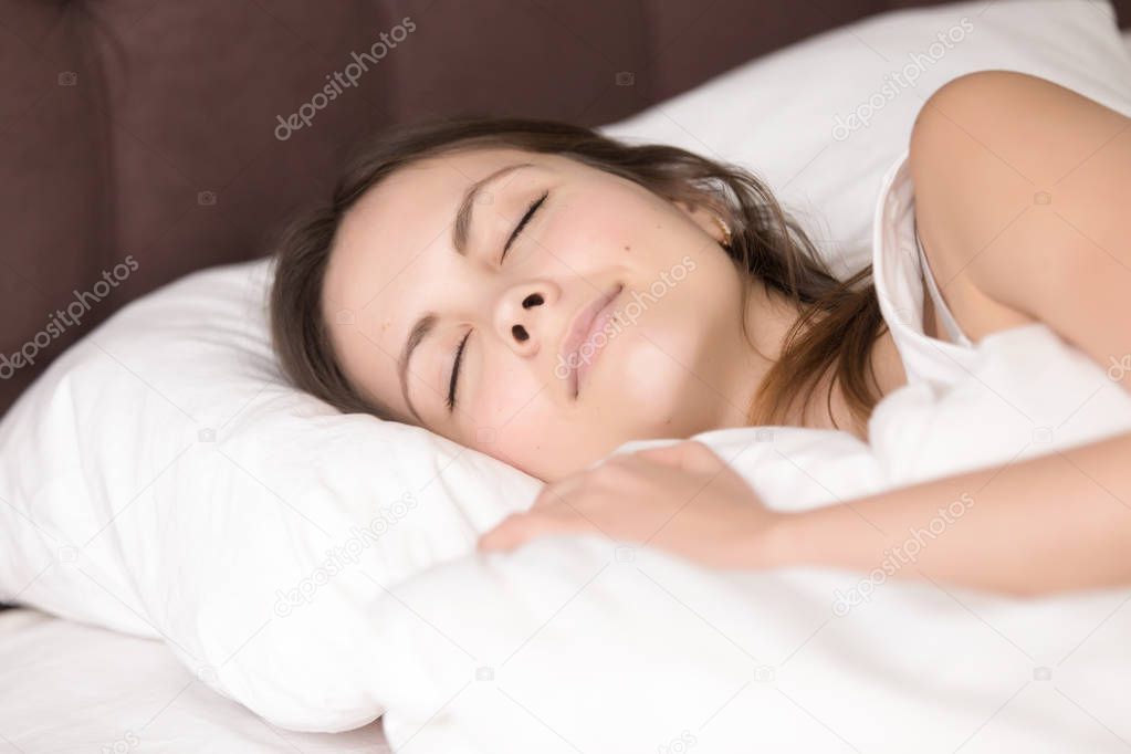 Pretty girl resting in bed, good deep healthy sleep, headshot