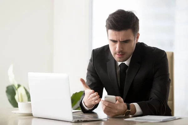 Irritated businessman annoyed with phone call, bad message, brok