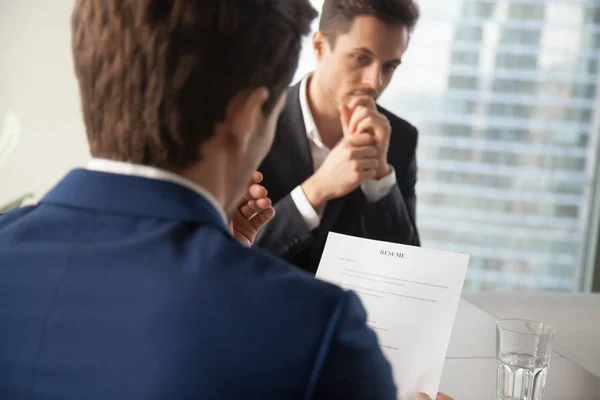 Hiring manager reading job candidates resume — Stock Photo, Image