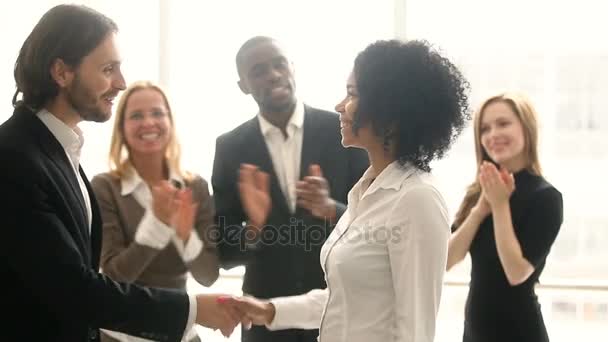 Company boss handshaking african employee, promoting congratulating black young woman