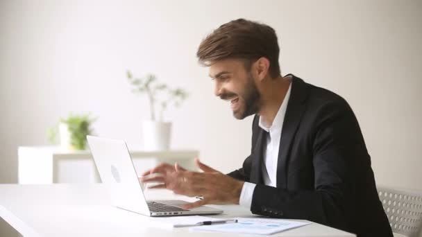 Feliz hombre de negocios mirando a la computadora portátil riendo emocionado por ganar en línea — Vídeos de Stock