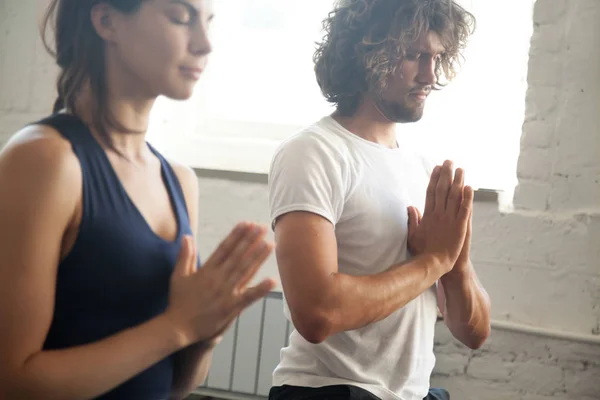 Group of young sporty people making namaste gesture — Stock Photo, Image