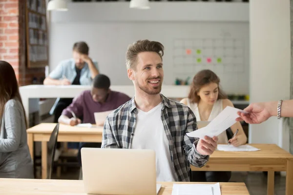 Smiling handsome entrepreneur giving financial document to cowor — Stock Photo, Image