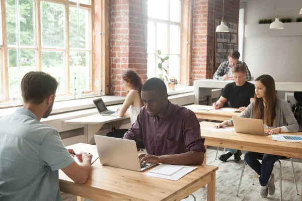 Multiethnic team of coworkers at work in shared office. — Stock Photo, Image