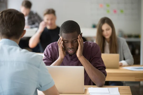 Stressed african-american entrepreneur having bad headache at wo — Stock Photo, Image