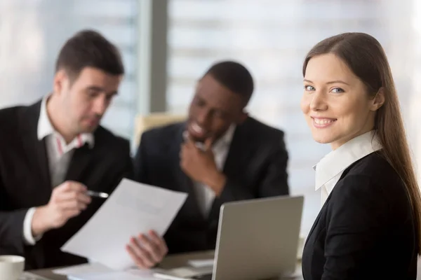 Female employee working with colleagues on meeting — Stock Photo, Image