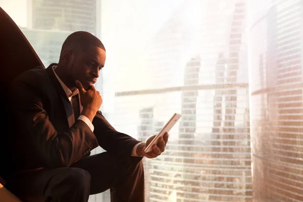 Black CEO reading news online with digital tablet — Stock Photo, Image