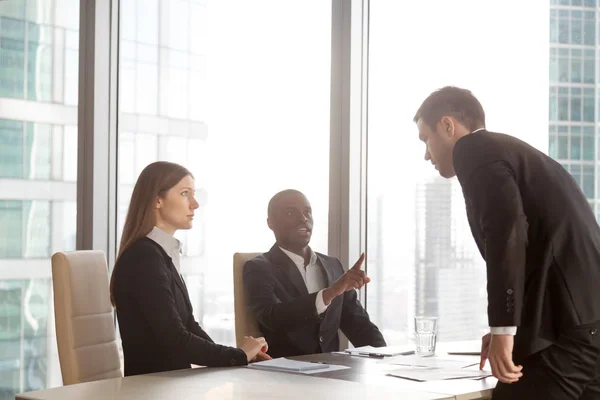 Businessman arguing with multi-ethnic partners