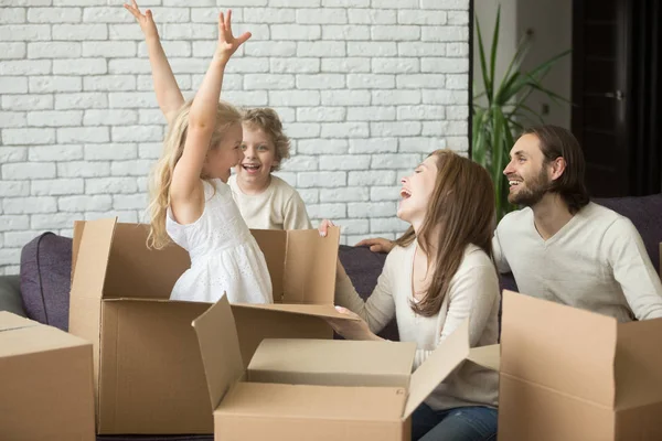 Glad tjej i kartong, familjen flyttar in flyttar conce — Stockfoto