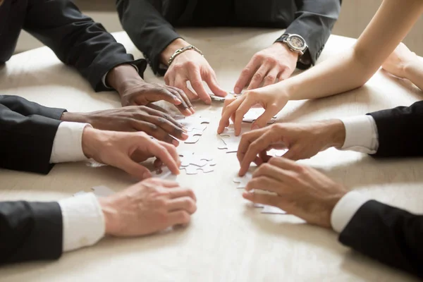 Diverse Business Team Assembling Jigsaw Puzzle Hands Joining Pieces Desk — Stock Photo, Image