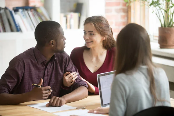 Young biracial diverse couple consulting before signing mortgage — Stock Photo, Image