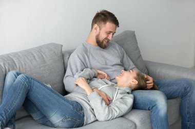 Genç çift kanepede evde hafta sonu zevk rahatlatıcı sevgi dolu