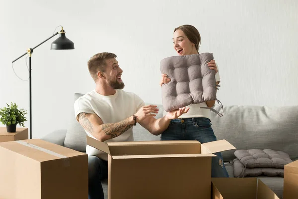 Feliz pareja tener divertido embalaje desembalaje cajas en sala de estar — Foto de Stock