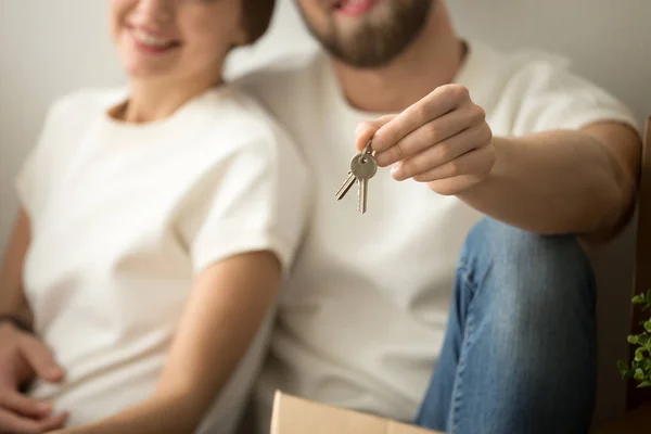 Happy new homeowners couple holding house keys, close up view — Stock Photo, Image