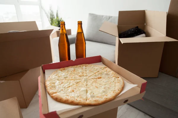 Pizza, beer and boxes, moving in celebration housewarming party