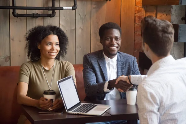 Smiling african-american couple shaking hands to broker advisor — Stock Photo, Image