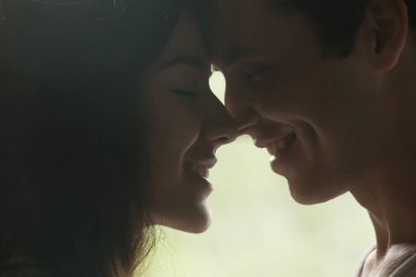 Seven erkek ve kadın birbirlerine öpücük yaklaşıyor