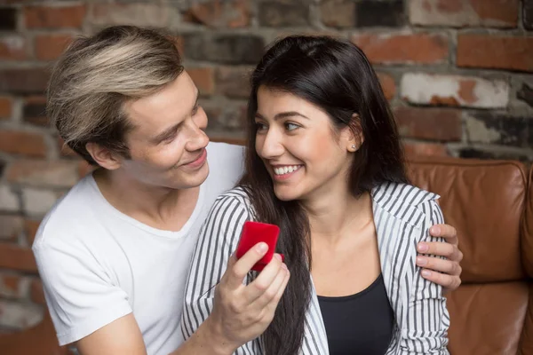 Man proposing to excited woman at home, holding ring box — Stock Photo, Image