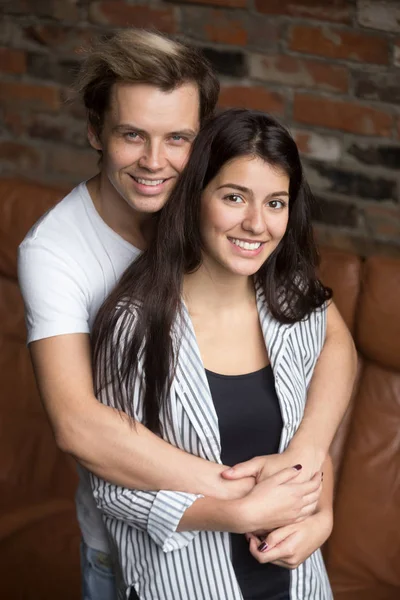 Vertical portrait of smiling attractive young couple looking at — Stock Photo, Image